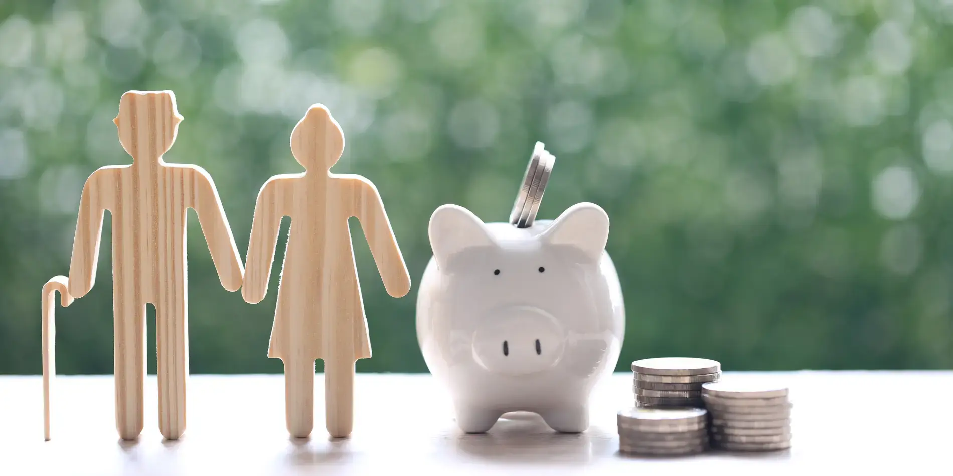 model wooden woman figure next to a piggy bank